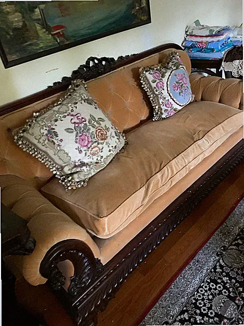 Antique caramel Tufted Sofa, Scroll Arms, Carved mahogany very comfy. “Friends”