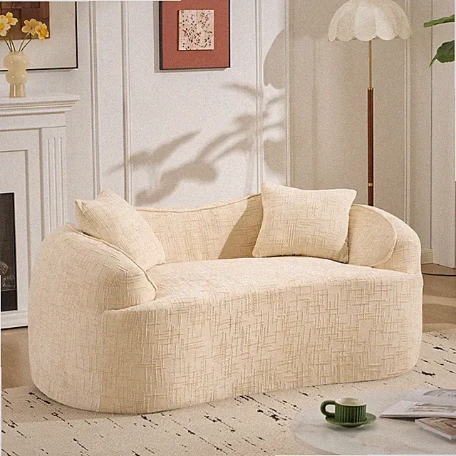 Beige curved two-person compress sofa. It has armrests on both sides,comes w/two