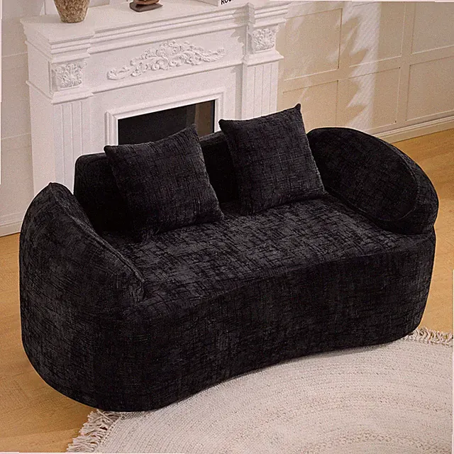 Black curved two-person compress sofa. It has armrests on both sides,comes w/two