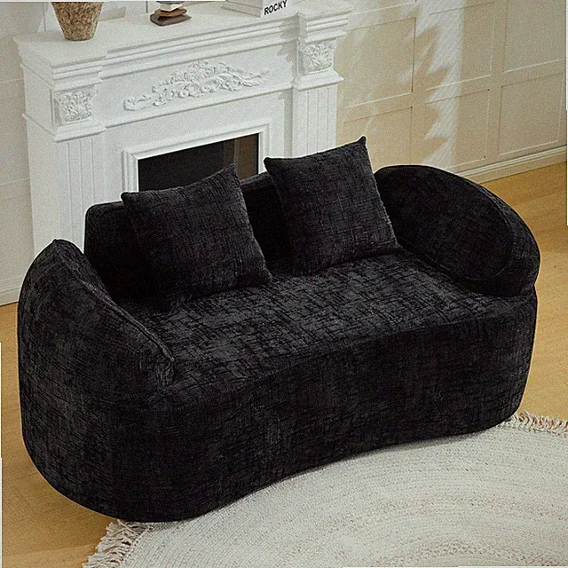 Black curved two - person compress sofa. It has armrests on both sides, comes wi