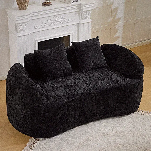 Black curved two - person compress sofa. It has armrests on both sides, comes wi