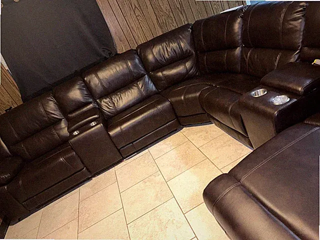 Brown leather sectional couch with cup holders and compartment to hold items