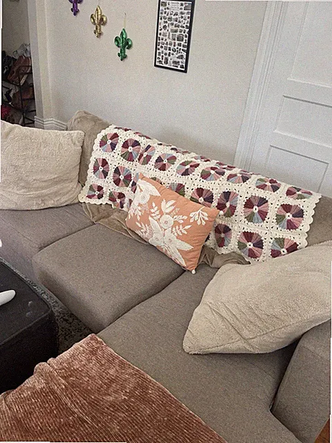 Comfortable grey L-shaped three cushion couch