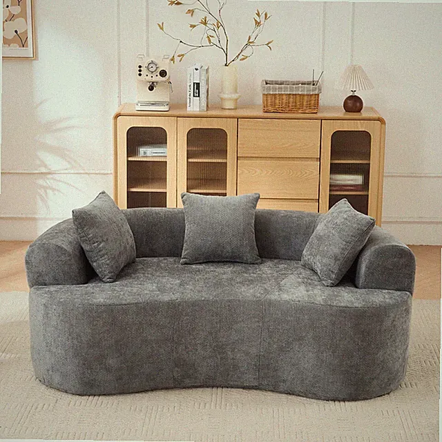 Crescent-shaped sofa, modern low-back design with deep cushions, featuring a sel