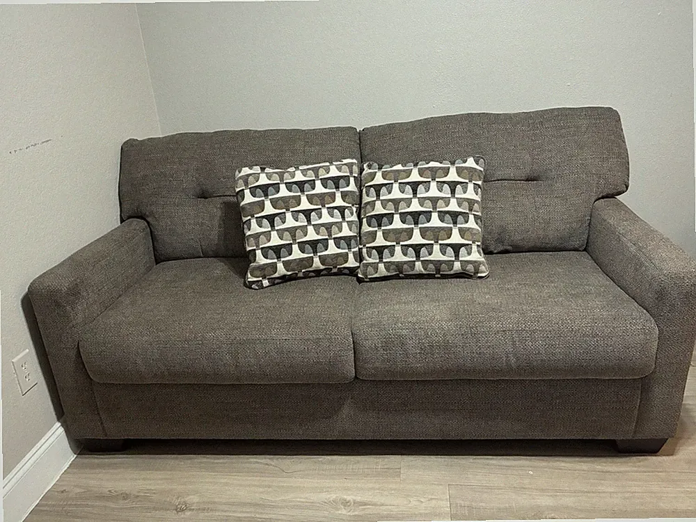 dark grey loveseat sofa and great condition no wear and tear with two pillows