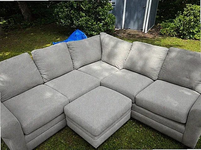Gray Sectional Sofa that has different forms. Ottoman also included as well