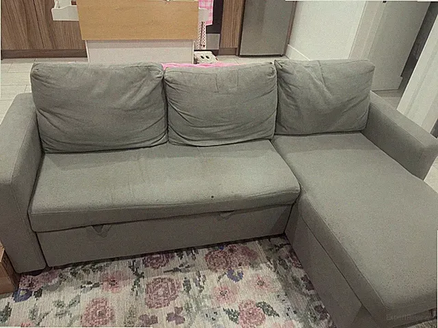 L shaped couch with pull out section, storage and charging port. Dark grey